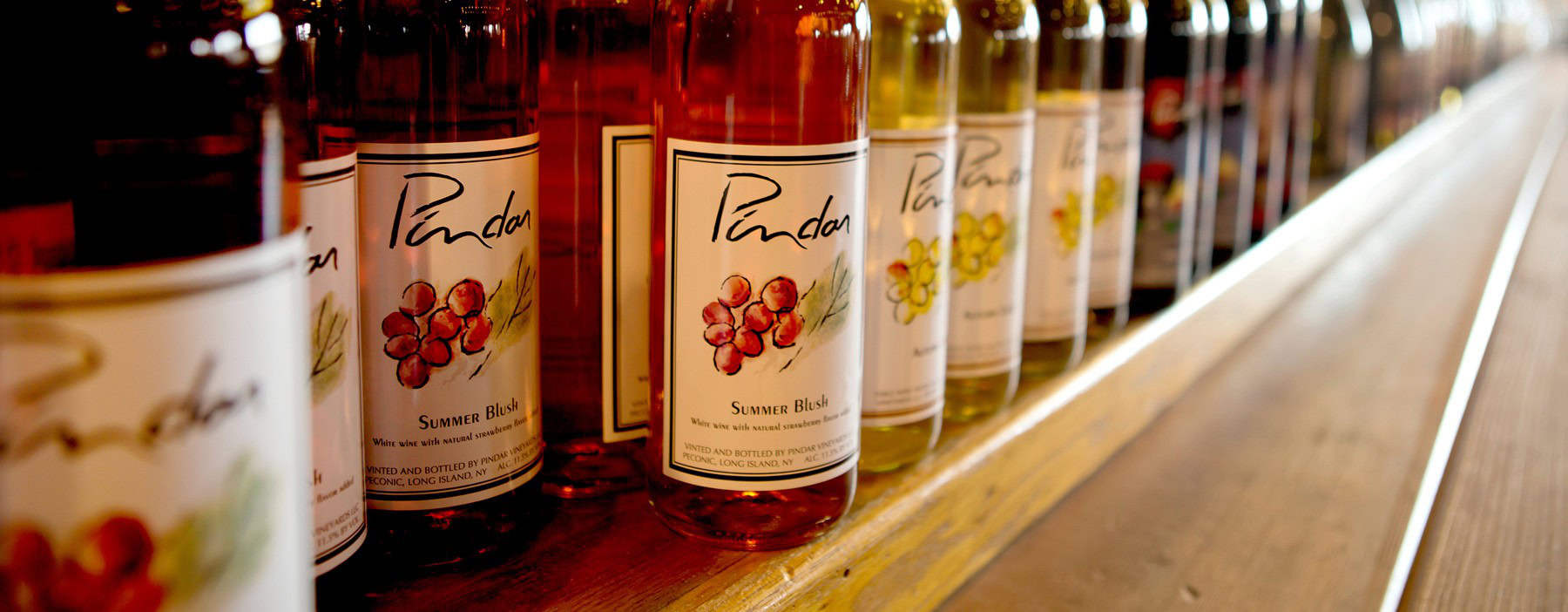 Bottles of Pindar Vineyards summer blend wine on display.