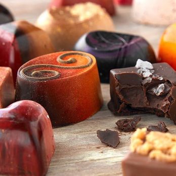Assorted handcrafted chocolates at Pindar Vineyards tasting room, showcasing rich flavors and textures.